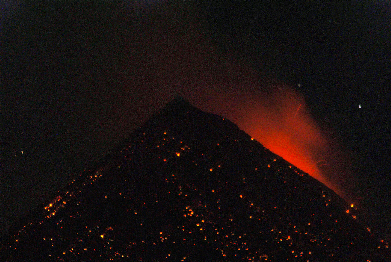 gua06_0641.jpg - volcan Fuego face aux tentes plantées sur l'Acatenango à 3500m, un spectacle extraordinaire : l'éruption principale est nettement au sud-ouest, mais les retombées de magma fluide ruissellent ensuite sur le cône volcanique avant de s'éteindre, le tout en moins de 30 secondes